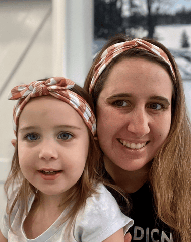 Mom and daughter are wearing matching mommy and me headbands from By Bella Boutique. Mom and daughter are wearing matching mommy and me headbands from By Bella Boutique.