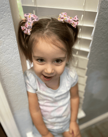 Little girl is wearing a pair of bow clips for toddler girls from By Bella Boutique. Little girl is wearing a pair of bow clips for toddler girls from By Bella Boutique.