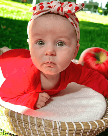 Baby girl is wearing a comfortable baby headband for little girls from By Bella Boutique. Baby girl is wearing a comfortable baby headband for little girls from By Bella Boutique.