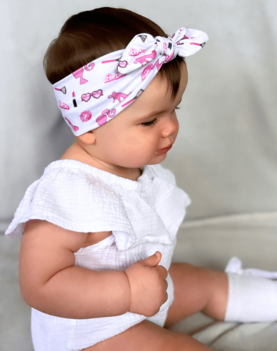 Baby girl is wearing a soft baby head wrap for little girls from By Bella Boutique. Baby girl is wearing a soft baby head wrap for little girls from By Bella Boutique.