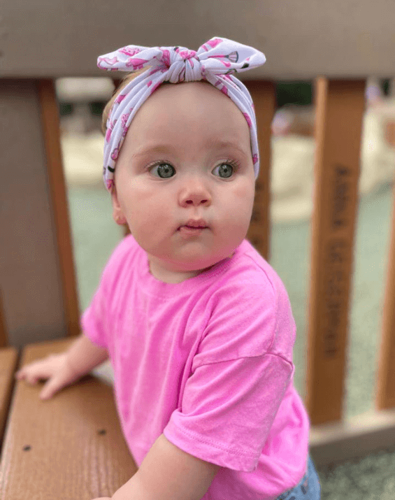 Baby girl is wearing a soft baby headband for little girls from By Bella Boutique. Baby girl is wearing a soft baby headband for little girls from By Bella Boutique.