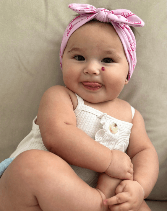 Baby girl is wearing a soft baby head wrap for little girls from By Bella Boutique. Baby girl is wearing a soft baby head wrap for little girls from By Bella Boutique.