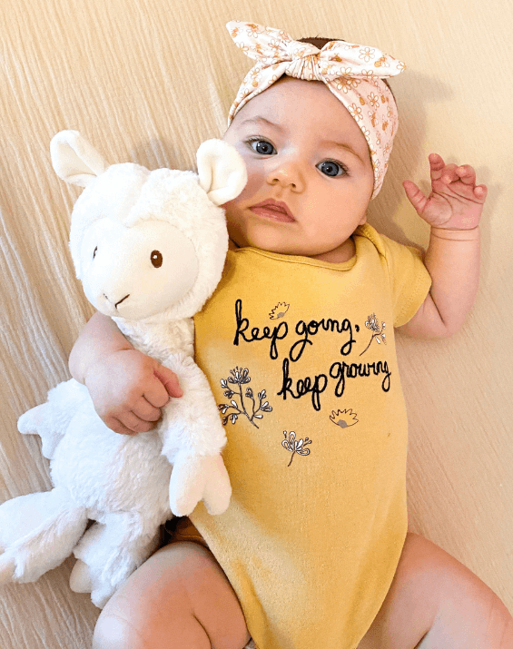 Baby girl is wearing a comfortable baby headband for little girls from By Bella Boutique. Baby girl is wearing a comfortable baby headband for little girls from By Bella Boutique.