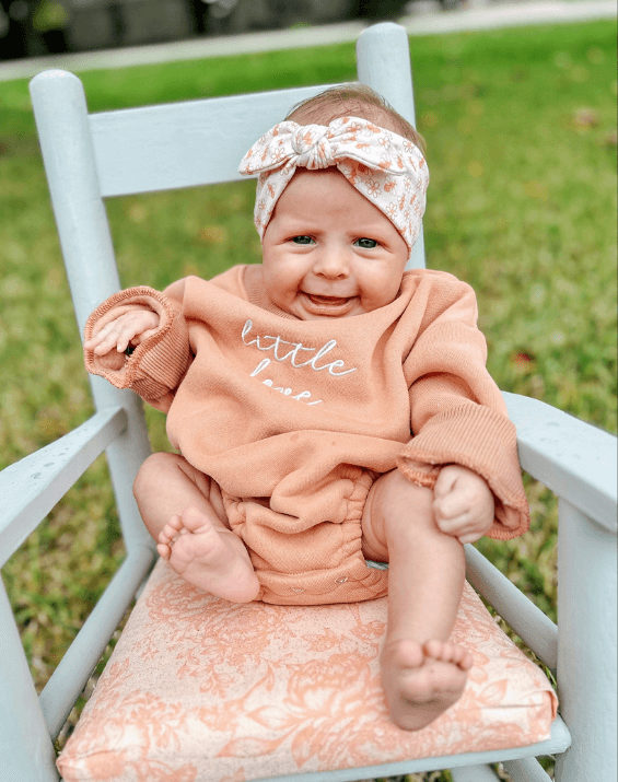 Little girl is wearing a comfortable baby headband for little girls from By Bella Boutique. Little girl is wearing a comfortable baby headband for little girls from By Bella Boutique.