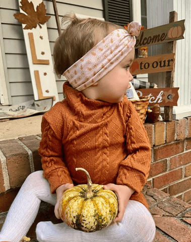 Little girl is wearing a comfortable baby headband for little girls from By Bella Boutique. Little girl is wearing a comfortable baby headband for little girls from By Bella Boutique.