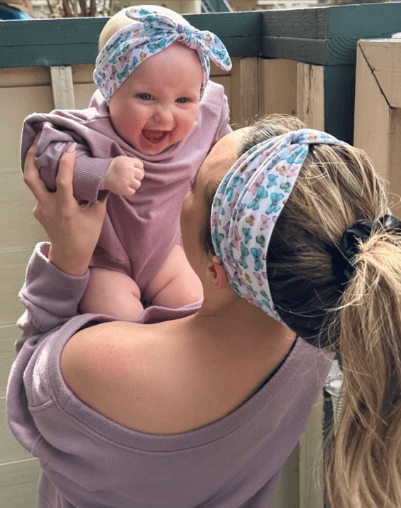 Mom and baby girl are wearing matching mommy and me headbands from By Bella Boutique. Mom and baby girl are wearing matching mommy and me headbands from By Bella Boutique.