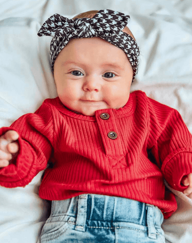Little girl is wearing a soft baby headband for little girls from By Bella Boutique. Little girl is wearing a soft baby headband for little girls from By Bella Boutique.