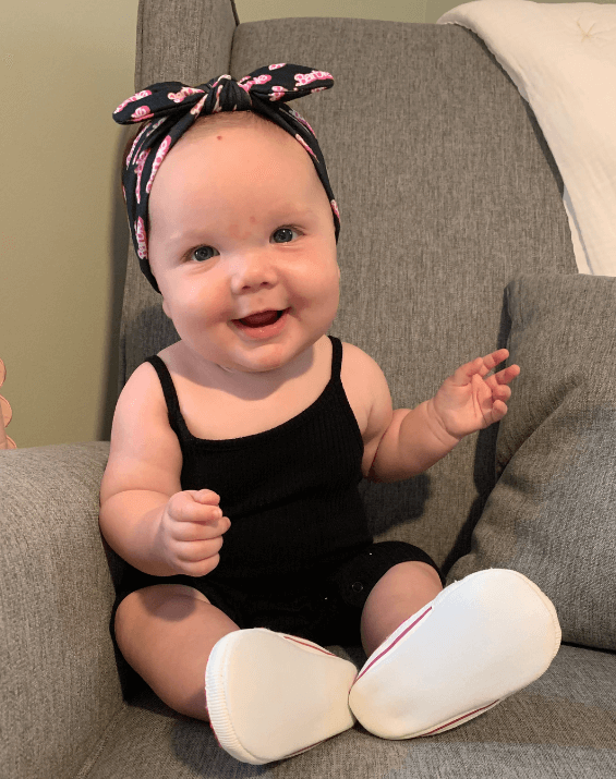 Baby girl is wearing a comfortable baby headband for little girls from By Bella Boutique. Baby girl is wearing a comfortable baby headband for little girls from By Bella Boutique.
