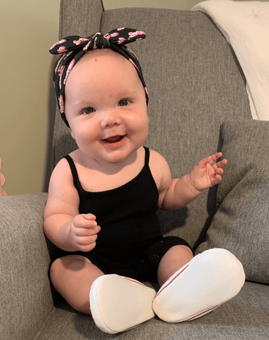 Baby girl is wearing a comfortable baby headband for little girls from By Bella Boutique. Baby girl is wearing a comfortable baby headband for little girls from By Bella Boutique.