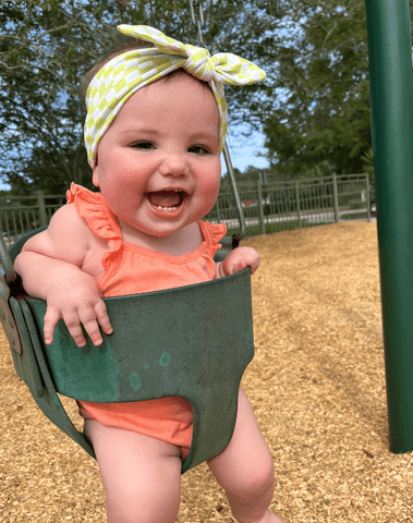 Baby girl is wearing a baby head wrap for little girls from By Bella Boutique. Baby girl is wearing a baby head wrap for little girls from By Bella Boutique.