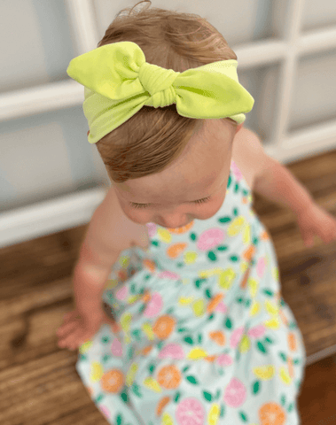 Baby girl is wearing a comfortable baby headwrap for little girls from By Bella Boutique. Baby girl is wearing a comfortable baby headwrap for little girls from By Bella Boutique.