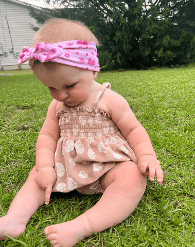 Baby girl is wearing a comfortable baby headband for little girls from By Bella Boutique. Baby girl is wearing a comfortable baby headband for little girls from By Bella Boutique.