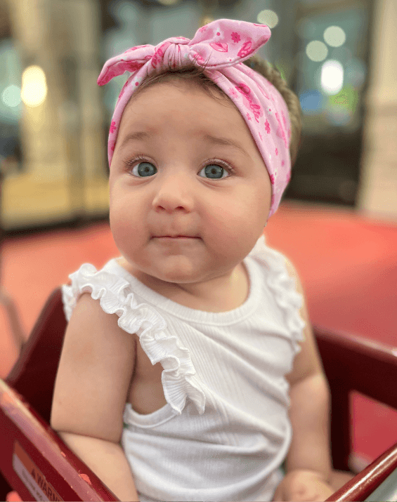 Little girl is wearing a baby headband for little girls from By Bella Boutique. Little girl is wearing a baby headband for little girls from By Bella Boutique.