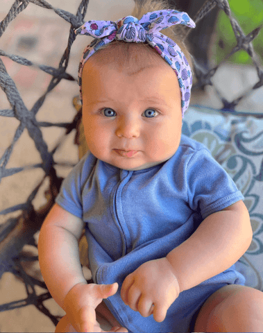 Baby girl is wearing a soft baby head wrap for little girls from By Bella Boutique. Baby girl is wearing a soft baby head wrap for little girls from By Bella Boutique.