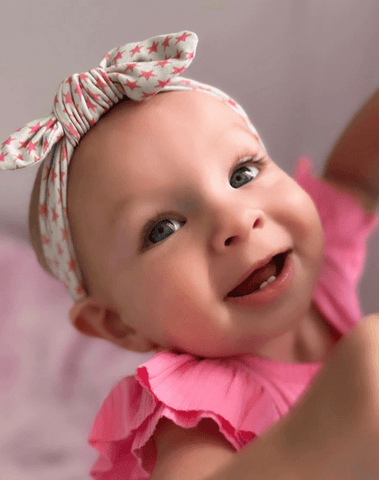 Baby girl is wearing a baby head wrap for little girls from By Bella Boutique. Baby girl is wearing a baby head wrap for little girls from By Bella Boutique.