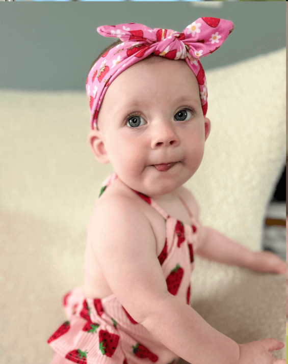 Baby girl is wearing a soft baby headband for little girls from By Bella Boutique. Baby girl is wearing a soft baby headband for little girls from By Bella Boutique.