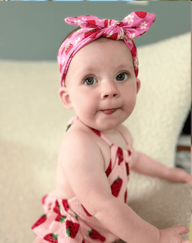Baby girl is wearing a soft baby headband for little girls from By Bella Boutique. Baby girl is wearing a soft baby headband for little girls from By Bella Boutique.