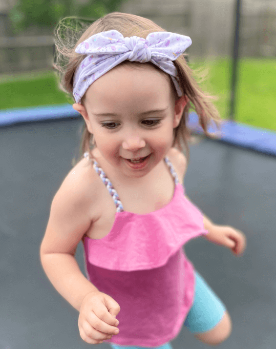 Little girl is wearing a baby headband for little girls from By Bella Boutique. Little girl is wearing a baby headband for little girls from By Bella Boutique.