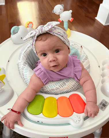 Little girl is wearing a comfortable baby head wrap for little girls from By Bella Boutique. Little girl is wearing a comfortable baby head wrap for little girls from By Bella Boutique.