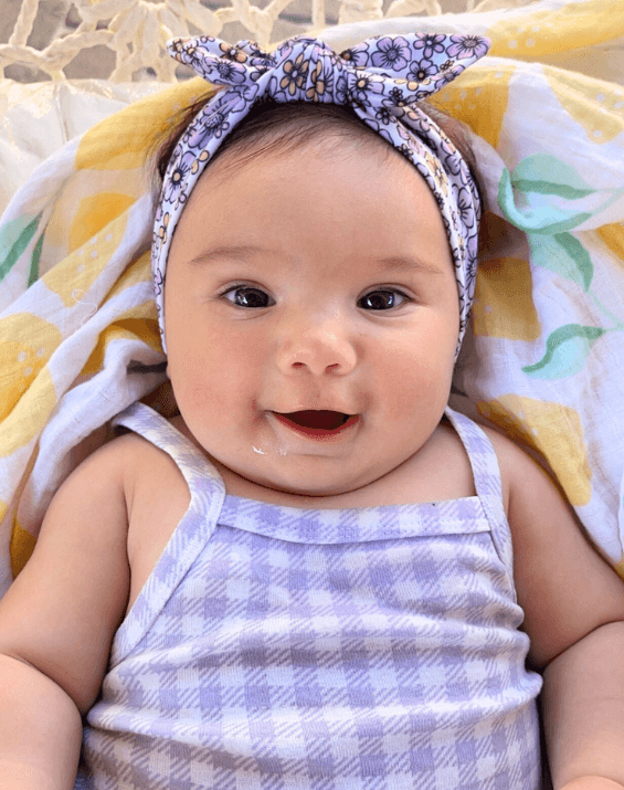 Little girl is wearing a comfortable baby headband for little girls from By Bella Boutique. Little girl is wearing a comfortable baby headband for little girls from By Bella Boutique.