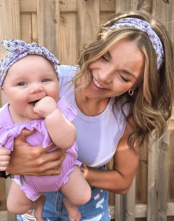 Mom and daughter are wearing matching mommy and me head wraps from By Bella Boutique. Mom and daughter are wearing matching mommy and me head wraps from By Bella Boutique.