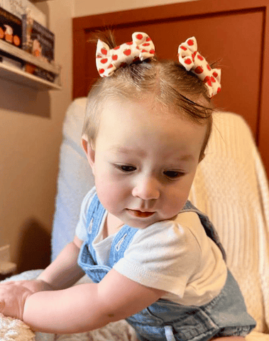 Little girl is wearing a pair of clip bows for toddler girls from By Bella Boutique. Little girl is wearing a pair of clip bows for toddler girls from By Bella Boutique.