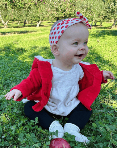 Little girl is wearing a baby headband for little girls from By Bella Boutique. Little girl is wearing a baby headband for little girls from By Bella Boutique.