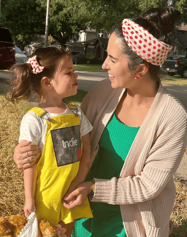 Mom and daughter are wearing matching mommy and me head wraps from By Bella Boutique. Mom and daughter are wearing matching mommy and me head wraps from By Bella Boutique.