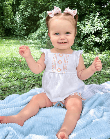Toddler girl is wearing a set of two bow clips featuring a boho style print for toddler girls from By Bella Boutique. Toddler girl is wearing a set of two bow clips featuring a boho style print for toddler girls from By Bella Boutique.