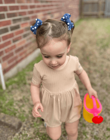 Toddler girl is wearing a set of clip bows for toddler girls from By Bella Boutique. Toddler girl is wearing a set of clip bows for toddler girls from By Bella Boutique.