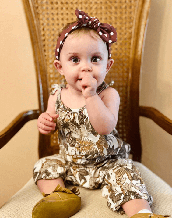 Baby girl is wearing a comfortable baby head wrap for little girls from By Bella Boutique. Baby girl is wearing a comfortable baby head wrap for little girls from By Bella Boutique.