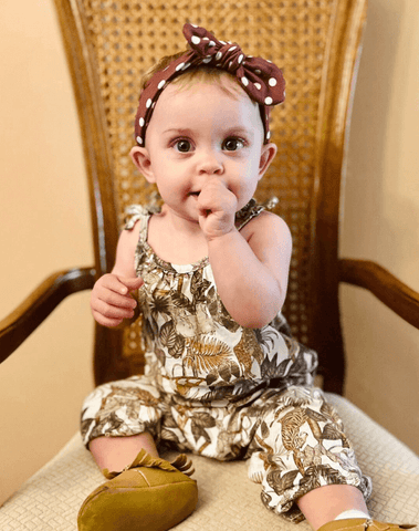Baby girl is wearing a comfortable baby head wrap for little girls from By Bella Boutique. Baby girl is wearing a comfortable baby head wrap for little girls from By Bella Boutique.