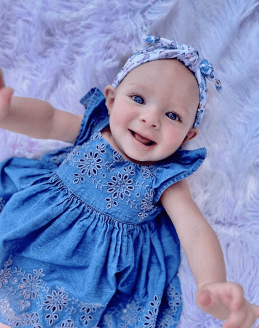 Little girl is wearing a knotted headband for little girls from By Bella Boutique. Little girl is wearing a knotted headband for little girls from By Bella Boutique.