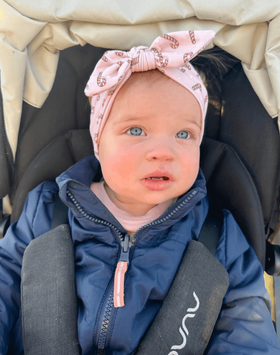 Little girl is wearing a comfortable baby headband for little girls from By Bella Boutique. Little girl is wearing a comfortable baby headband for little girls from By Bella Boutique.