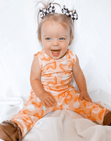 Toddler girl is wearing a set of handmade clip bows from By Bella Boutique. Toddler girl is wearing a set of handmade clip bows from By Bella Boutique.