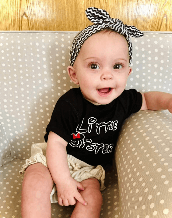 Baby girl is wearing a top knot headband featuring a chevron print from By Bella Boutique.  Baby girl is wearing a top knot headband featuring a chevron print from By Bella Boutique.
