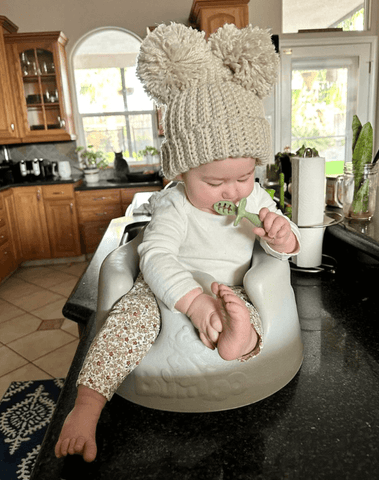 Little girl is wearing a handmade baby beanie for little girls from By Bella Boutique. Little girl is wearing a handmade baby beanie for little girls from By Bella Boutique.
