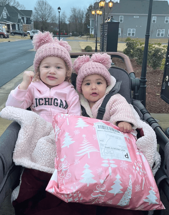 Little girls are wearing handmade beanies from By Bella Boutique. Little girls are wearing handmade beanies from By Bella Boutique.