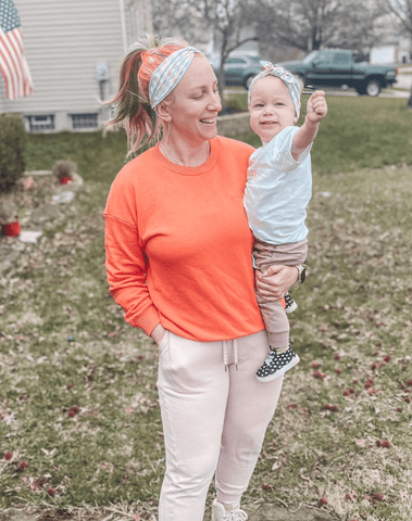 Mother and daughter are wearing matching mommy and me head wraps for little girls from By Bella Boutique.