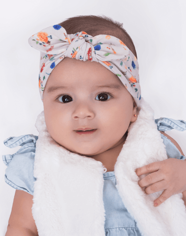 Baby girl is wearing a cute blue and orange flower headband from By Bella Boutique. Baby girl is wearing a cute blue and orange flower headband from By Bella Boutique.