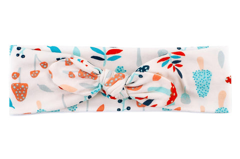 A top knot headband featuring a boho mushroom print from By Bella Boutique. A top knot headband featuring a boho mushroom print from By Bella Boutique.