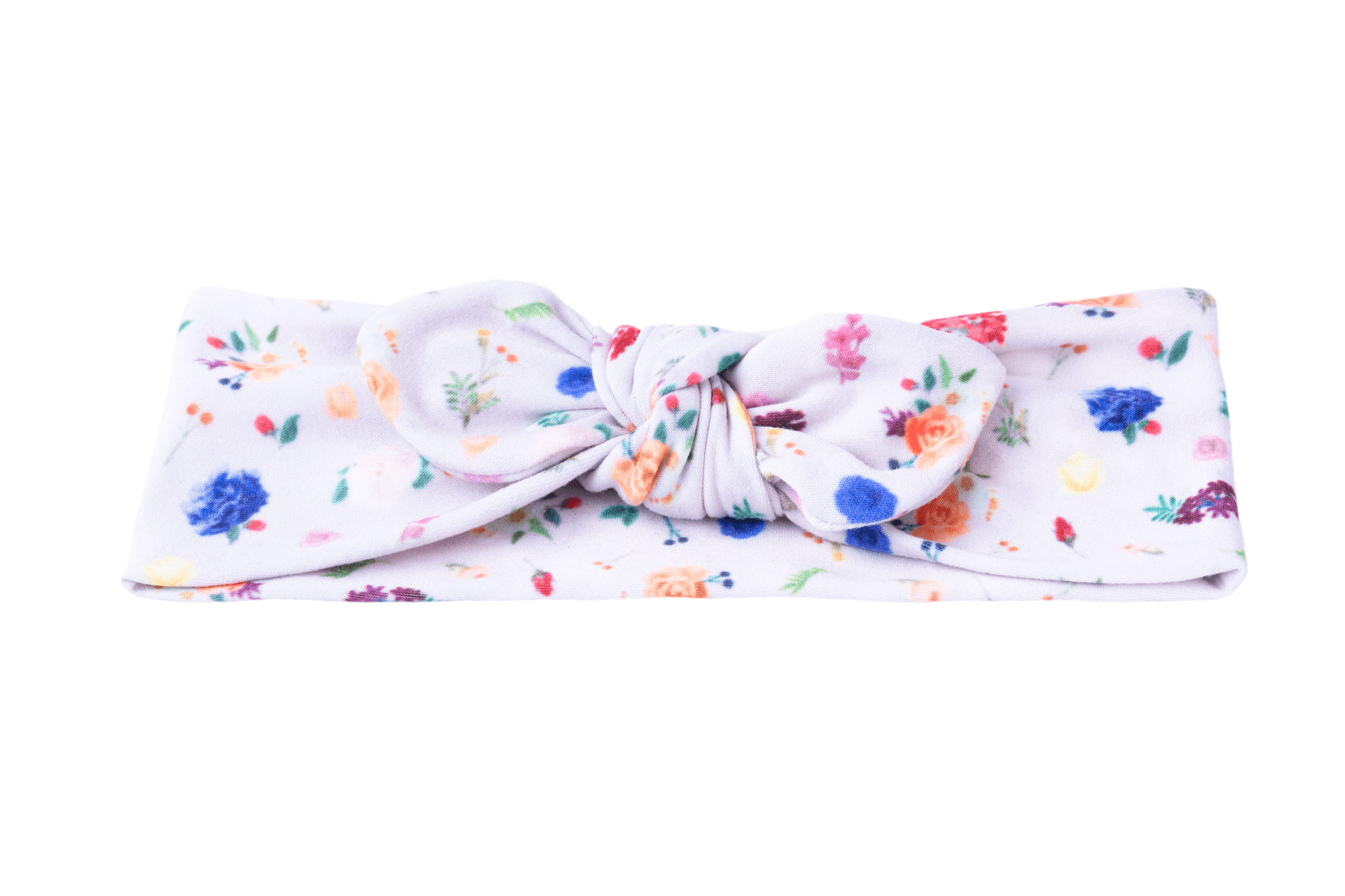 A knotted headband featuring a flower pattern for little girls from By Bella Boutique. A knotted headband featuring a flower pattern for little girls from By Bella Boutique.