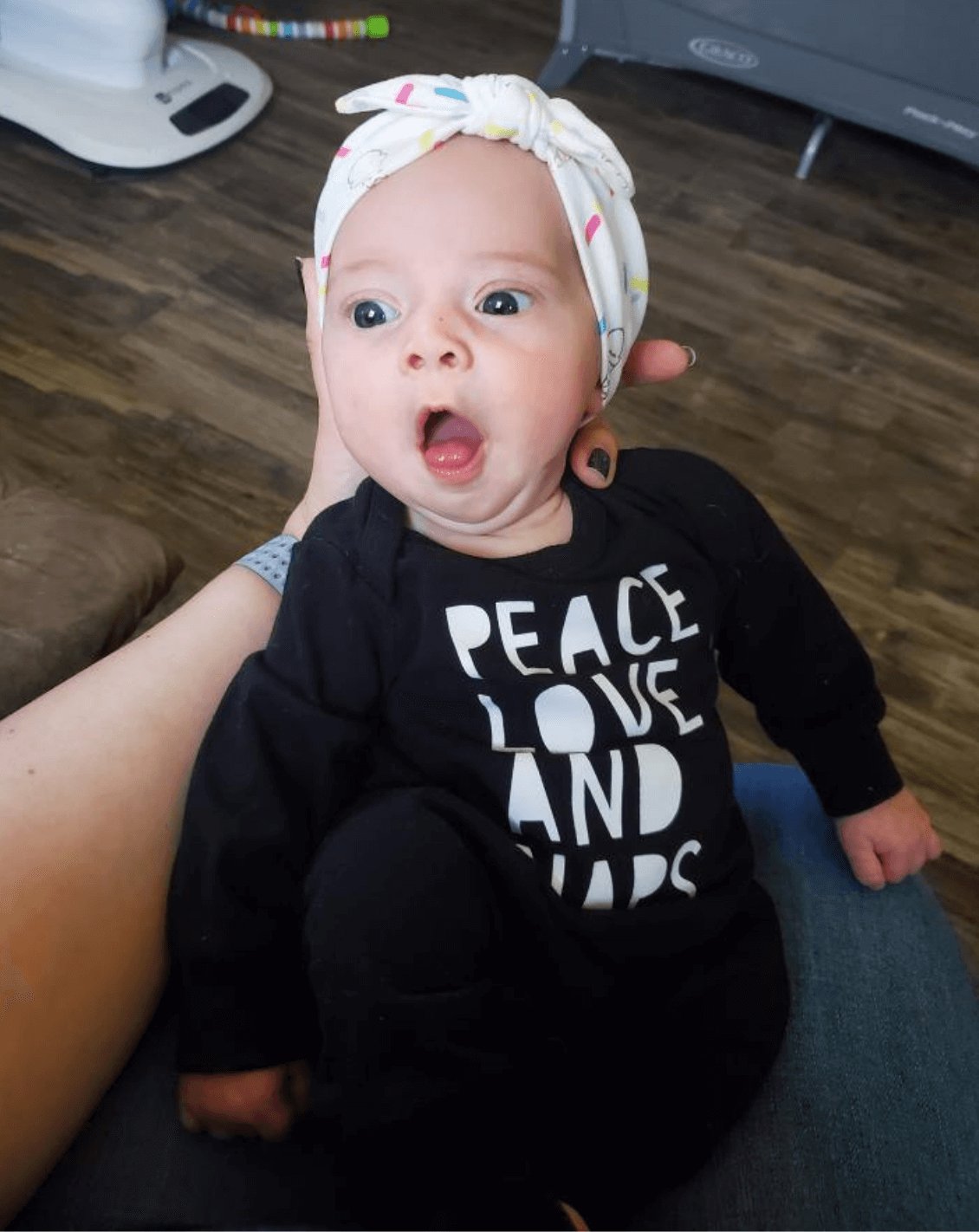 Baby girl is wearing a top knot headband featuring an ice cream pattern from By Bella Boutique. Baby girl is wearing a top knot headband featuring an ice cream pattern from By Bella Boutique.