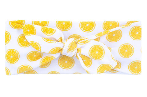 A knotted headband featuring a lemon pattern for little girls from By Bella Boutique.  A knotted headband featuring a lemon pattern for little girls from By Bella Boutique.