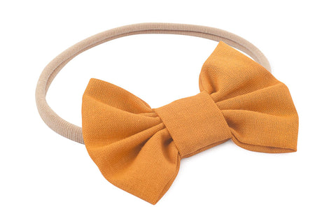 Mustard nylon headband for newborns from By Bella Boutique. Mustard nylon headband for newborns from By Bella Boutique.