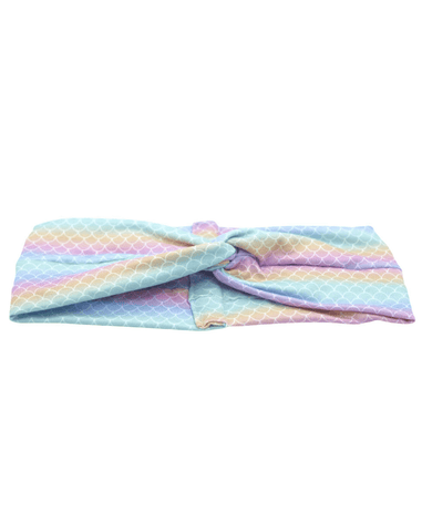 A turban headband featuring a mermaid pattern for women from By Bella Boutique. A turban headband featuring a mermaid pattern for women from By Bella Boutique.