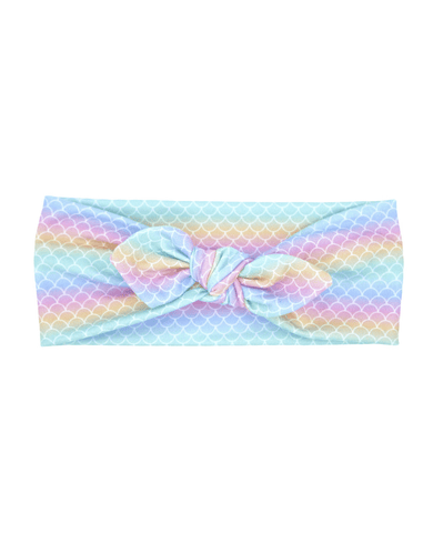 A top knot headband featuring a mermaid pattern from By Bella Boutique. A top knot headband featuring a mermaid pattern from By Bella Boutique.