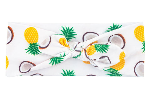 Knotted headband featuring a piña colada pattern from By Bella Boutique.  Knotted headband featuring a piña colada pattern from By Bella Boutique.