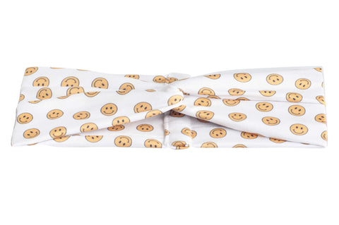 A twist headband featuring a smiley pattern for women from By Bella Boutique. A twist headband featuring a smiley pattern for women from By Bella Boutique.
