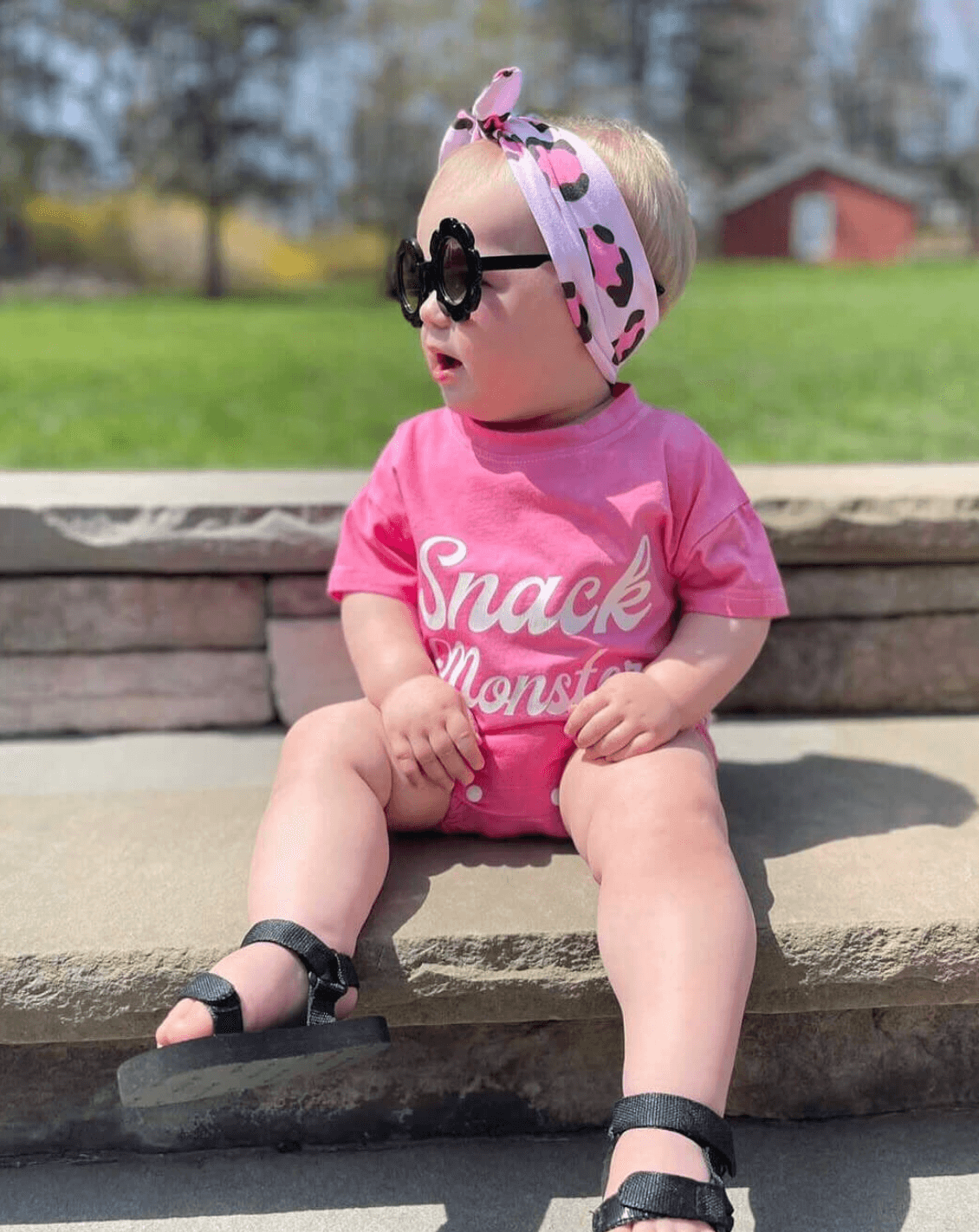 Baby girl is wearing a knotted headband featuring a pink leopard pattern from By Bella Boutique. Baby girl is wearing a knotted headband featuring a pink leopard pattern from By Bella Boutique.